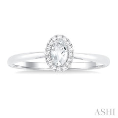 5x3 MM Oval Shape White Topaz and 1/20 Ctw Single Cut Diamond Halo Semi-Precious Ring in 10K White Gold